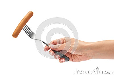 Female hand holds frankfurter sausage on a fork. Isolated on white background Stock Photo