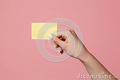 Female hand holds golden credit card Stock Photo