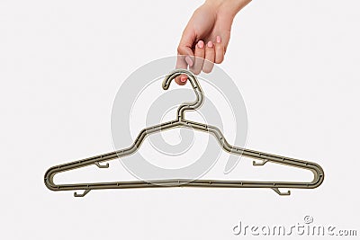 Female hand holds a hanger. White background. hook woman Stock Photo