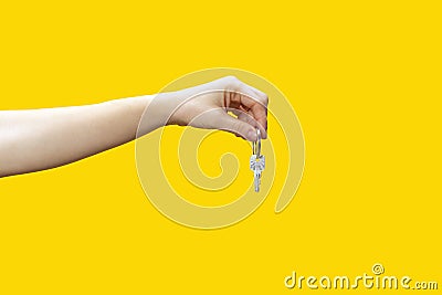 Female hand holds out key. Love concept, consent to marry, acceptance of offer Stock Photo