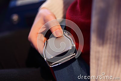 Female hand with a lock of the seat belt Stock Photo