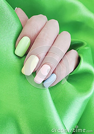 Female hand manicure colored elegance serenity beauty silk fabric Stock Photo