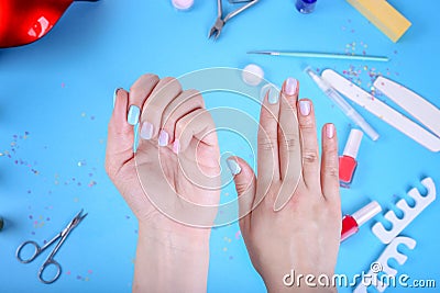 Female hand with ombre manicure on a blue background. Blue manicure with nail polish. Top view Stock Photo