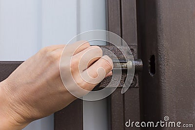 Female hand open or close metal latch lock Stock Photo