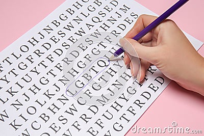 Female hand outlining abbreviation LGBTQ on sheet of paper Stock Photo