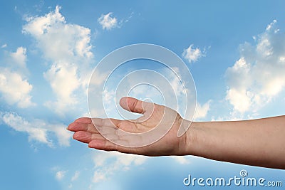 Female hand outstretched against beautiful summer landscape, blue sky with clouds, concept of transcendence, infinity, height, the Stock Photo