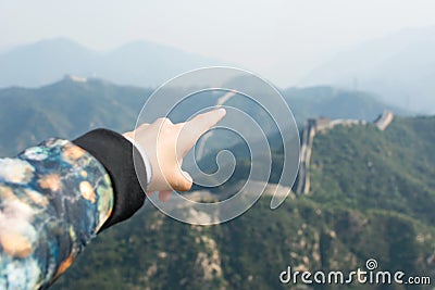 Female hand pointing the Great Wall of China Stock Photo