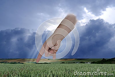 female hand points with index finger, dramatic thunderstorm sky with dark clouds, concept God's punishment, retribution for Stock Photo