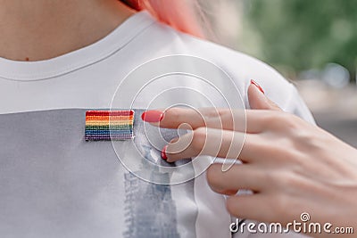 Female hand points to lgbt sign. LGBTQ, lgbt gay pride tolerance concept Stock Photo