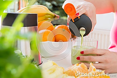 Female hand pours cocktail made of fresh fruit Stock Photo