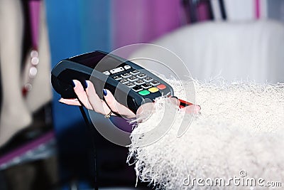 Female hand puts bankcard into reader on defocused background. Payment with credit card. EDC machine or credit card Stock Photo