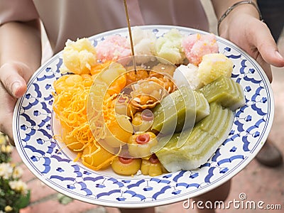 Female hand take a thai dessert in wedding caremony Stock Photo
