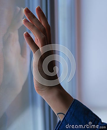 Female hand touches the window Stock Photo