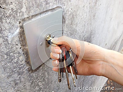 Female hand unlocks garage Stock Photo