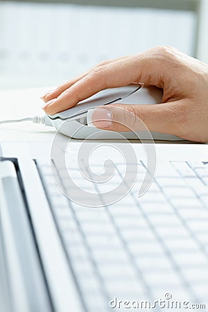 Female hand using computer mouse Stock Photo