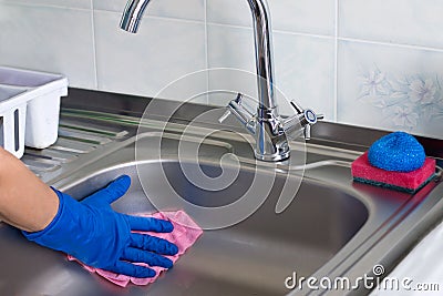 Female hand wipes dry kitehen sink Stock Photo