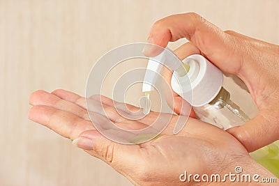 Female hands applying antibacterial liquid soap Stock Photo