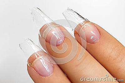 Female hands with beautiful colorful hybrid nails and professional manicure. Stock Photo
