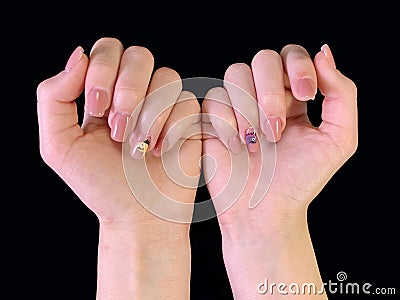 Female hands with a beautiful manicure, on a black background. Hands of a young girl, with manicured nails. The fingers of a young Stock Photo