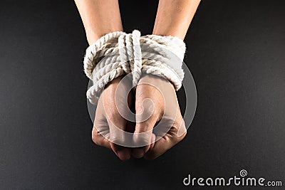 Female Hands Bound in Bondage with Rope Stock Photo