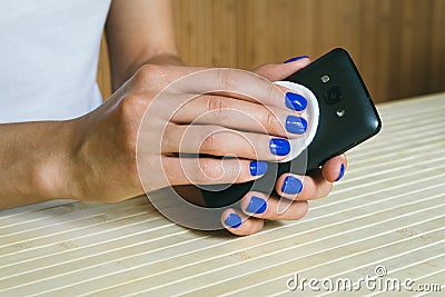 Female hands clean from dust and dirt a mobile phone Stock Photo