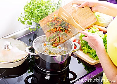 Female hands cooking vegetable soup Stock Photo