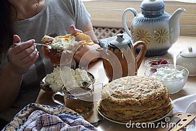 Female hands fill a pancake with cottage cheese Stock Photo