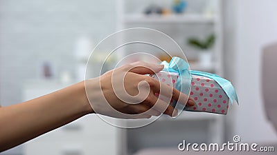 Female hands giving gift box, celebrating birthday, greeting close person Stock Photo