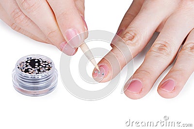 Female hands. Gluing a paste on nail. Stock Photo