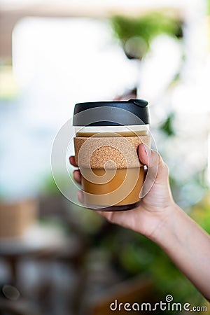 Female hands holding reusable coffee cup, Stock Photo