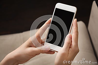Female hands hold white phone in their hands. Mobile phone close-up Stock Photo
