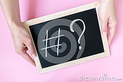 Hands holding chalkboard with hashtag sign Stock Photo