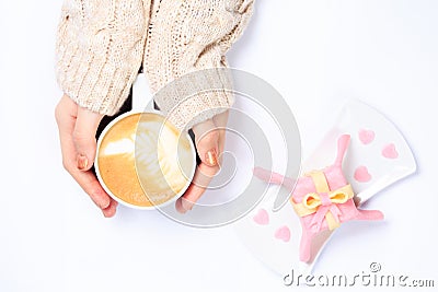 Female hands holding cup of cappuccino. Gift alike dessert with Stock Photo
