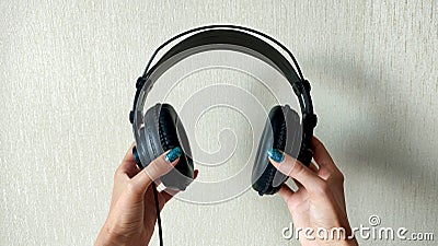 Female hands holding first-person headphones Stock Photo