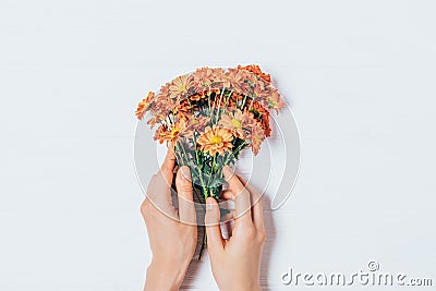 Female hands holding simple bouquet Stock Photo