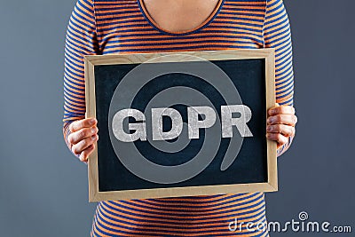 Female hands holding small chalkboard with GDPR text. Stock Photo