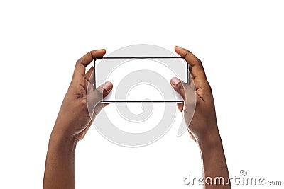 Female hands holding smartphone with blank screen, playing video games Stock Photo