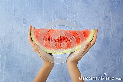 Female hands holding watermelon slice on light background Stock Photo