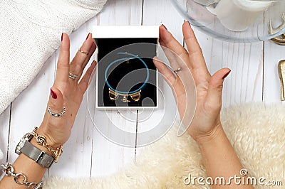 Female hands with gift. Fashion accessories, wrist watches, glamor bracelets Stock Photo