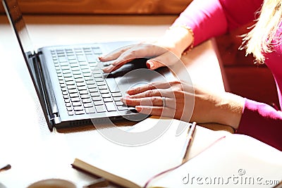 Female hands on the keyboard type text. Notebook, pen, mobile phone, cup of coffee on a table. Breakfast business person. Morning Stock Photo