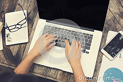 Female hands on laptop keyboard with another computer tablet on Stock Photo