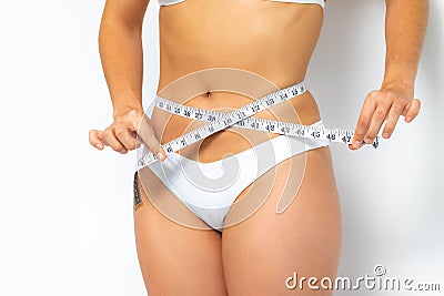 Female hands measuring waist with measure band. Stock Photo