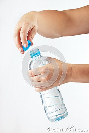 Female hands opening a small bottle of fresh water Stock Photo