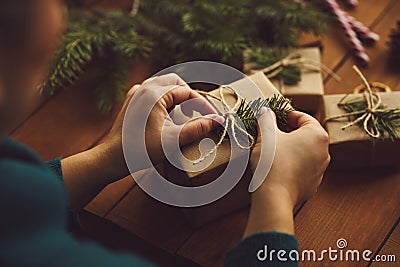 Female hands packing Christmas gifts on table Stock Photo