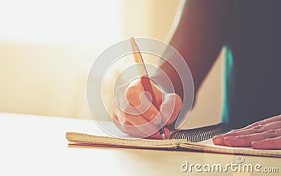 Female hands with pen writing Stock Photo