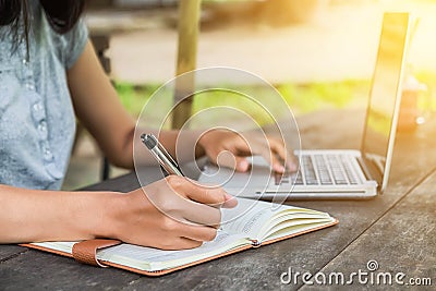 Female hands with pen writing notebook Stock Photo