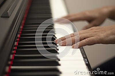 Female hands play the electric piano, Hand and piano keys close up Stock Photo