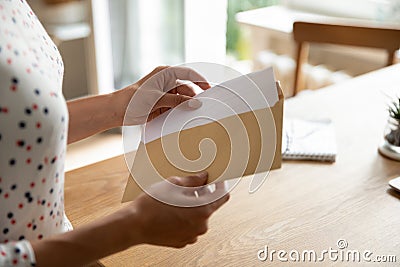 Female hands put letter in envelop before send by mail Stock Photo