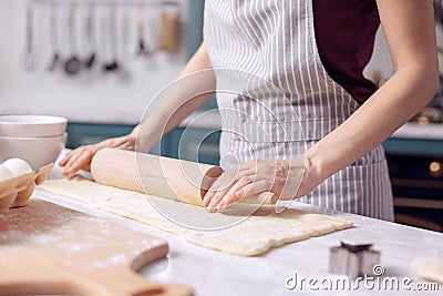 Female hands rolling out dough for biscuits Stock Photo