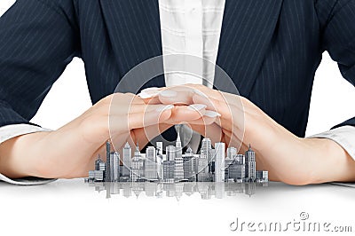Female hands saving small city with a roof Stock Photo